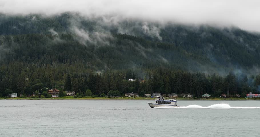Foggy mountains and a small boat sailing on Gastineau Channel, Juneau, Alaska Royalty-Free Stock Footage #3430294711