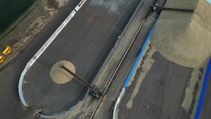 Modern machinery unloading grain, agri-food industry in Western Australia. Aerial drone view

