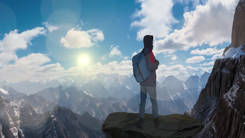 HIker Standing on Top of a Mountain Peak Looking at  Panorama of Mountains. Royalty-Free Stock Footage #3430362575