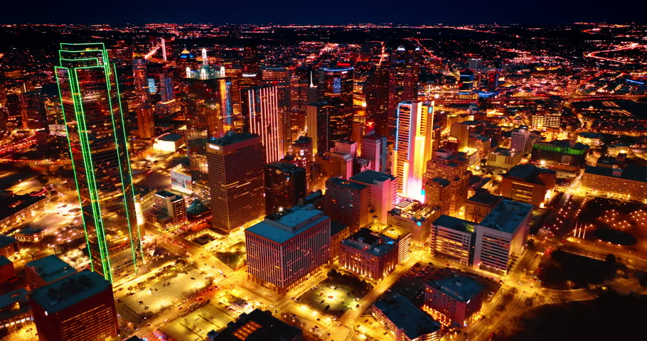 Footage rising above the dazzling well-lit panorama of Dallas, Texas, USA. Breath-taking view of metropolis at night.