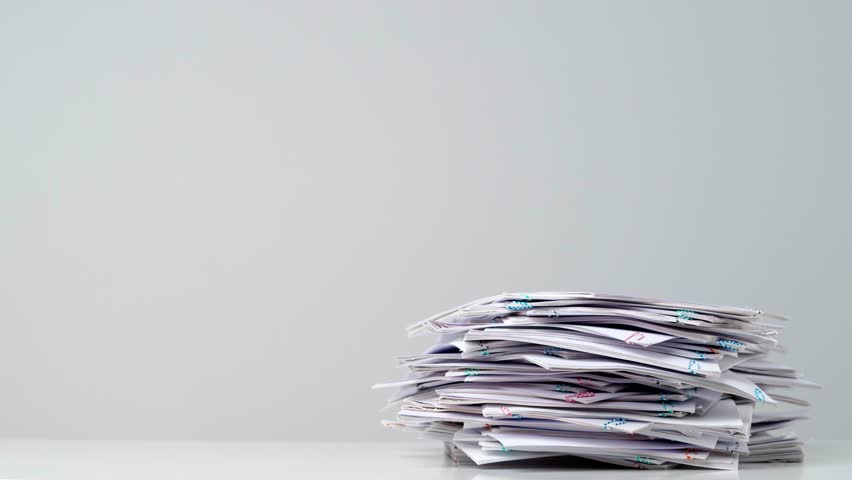 Time lapse shot of paper sheets. Stop motion animation of business or educational paper documents with paper clips increasing and decreasing.