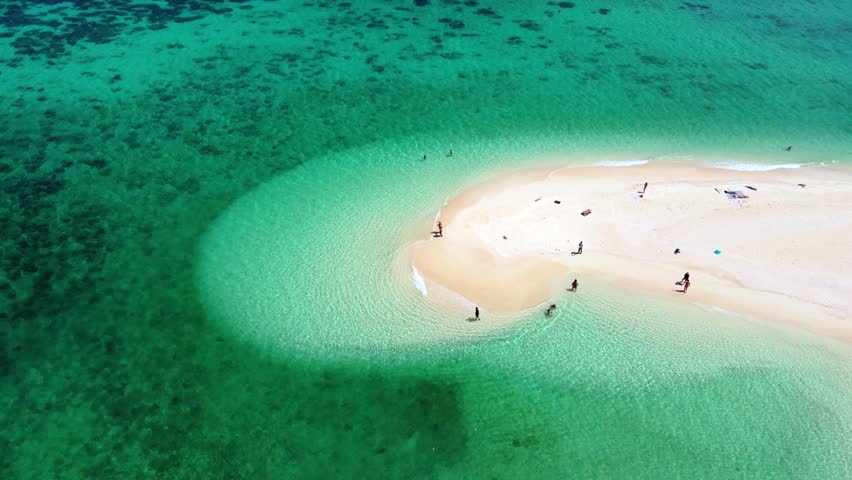 a couple of men and women at a white sandbank in the ocean of Koh Lipe Island Southern Thailand, with turqouse colored ocean and white sandy beach sandbar at Ko Lipe. Royalty-Free Stock Footage #3430487875