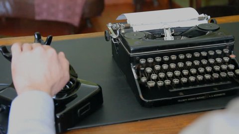 Desk. Vintage typewriter, old phone. 
