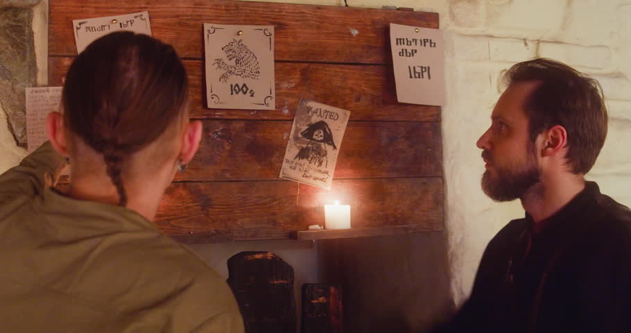 Alcoholics argue about job choice standing at bulletin board in tavern. Adventurers seek safe task to make easy money in medieval guesthouse. Fantasy role play
