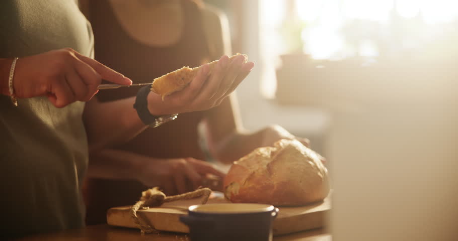 Woman, hands and lesbian couple with bread, spread or butter for meal, snack or wheat in kitchen at home. Closeup of female person, LGBTQ or gay people making food, breakfast or morning loaf on table