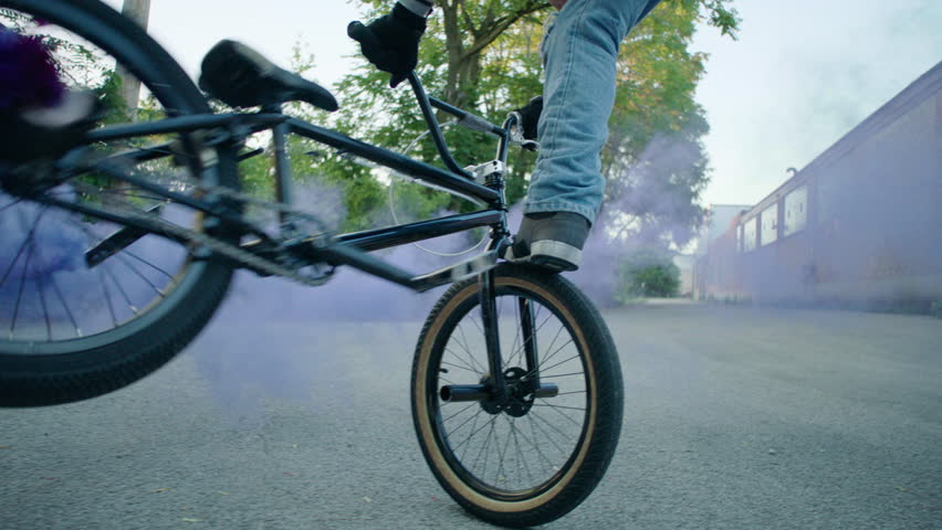 Man riding bike with fog