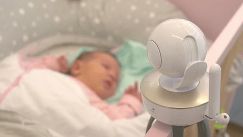 The baby monitor camera above the crib monitors the child in the bedroom in 4k slow motion 60fps Video de stock