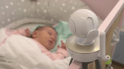 The baby monitor camera above the crib monitors the child in the bedroom in 4k slow motion 60fps Video de stock