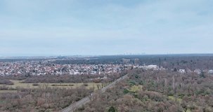 Time-lapse drone video of the Frankfurt skyline from the south with planes approaching the airport during the day