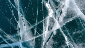 Aerial drone view frozen winter Lake Baikal. Blue transparent ice deep cracks top view. Natural cold background of ice. Winter abstract background. High quality 4k footage - Powered by Shutterstock - Get 15% off with code: PIKWIZARD15