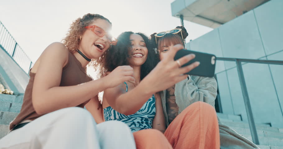 Selfie, laughing or friends with fashion in city on holiday vacation with youth culture, streetwear or smile. Funny, women or stylish urban clothing with social media, swag or diversity together