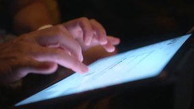 Close up male hands typing on tablet screen email or social media blog content at late night. Close view on bright screen of modern technical device. Businessman working online, wireless internet 4K - Powered by Shutterstock - Get 15% off with code: PIKWIZARD15