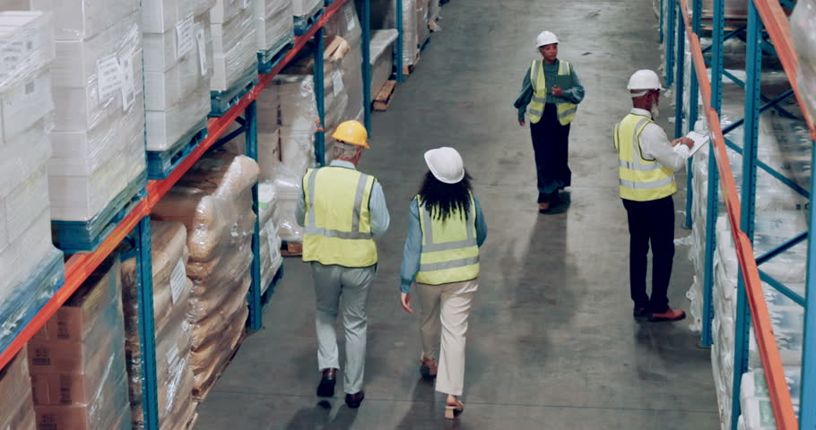 Delivery, storage and shelves with warehouse people walking together for logistics, stock or inspection. Industry, shipping and supply chain with employee team working in plant for cargo distribution