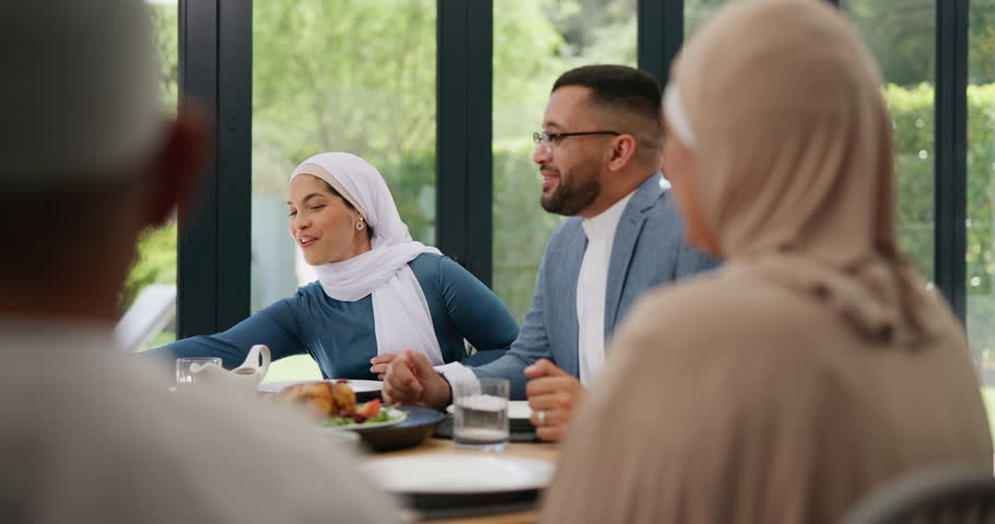 Muslim, family and friends with food or happy at dining table for eid, islamic celebration or hosting. Ramadan, culture and people talking at religious gathering for lunch, discussion or conversation Royalty-Free Stock Footage #3431110009