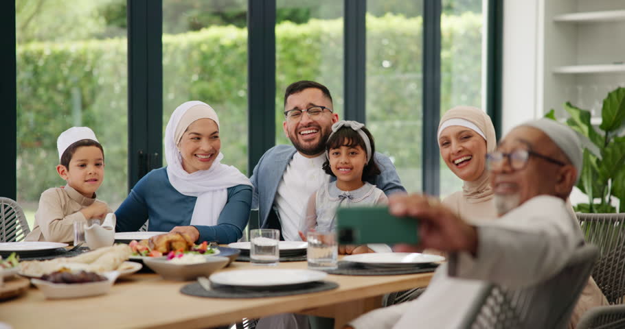 Muslim, selfie or happy family in home at lunch with smile or celebration of Eid or Ramadan in Dubai. Girl child, people eating food or profile picture at dinner or meal with grandparents, dad or mom Royalty-Free Stock Footage #3431166917