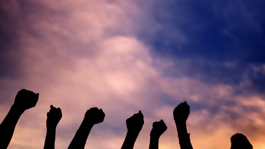 Fists of people raising angrily in the air facing sunset Royalty-Free Stock Footage #3431229963