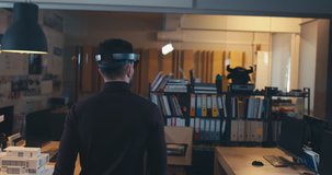 TRACKING young Caucasian male walking in the office, having a video call via augmented reality headset hololens. 4K UHD
