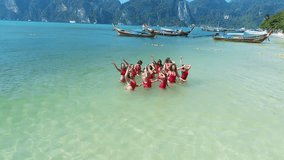 Aerial drone view of happy women in red swimsuits on the tropical vacation - video in slow motion