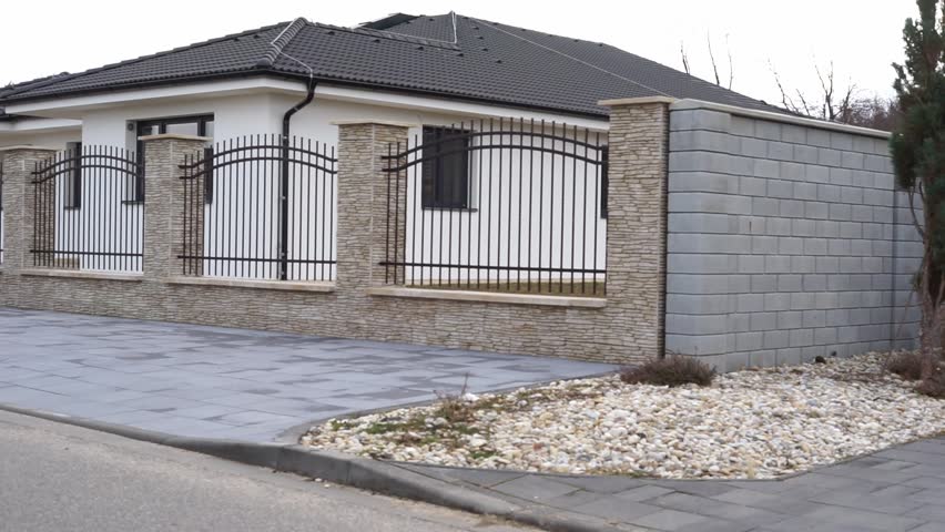 house behind a fence in the private sector