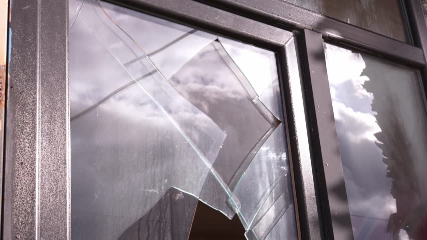 Broken glass in door or window on city street. Vandalism or theft from apartment, house or shop. Street riots. Bandis robbed store. Elements and strong hurricane with wind damaged facade of building.