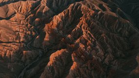Cinematic aerial view of the mountains at sunset. Fairy Tale Canyon in Kyrgyzstan. Geological landscape wind, weather erosion.