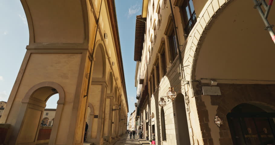 Beautiful urban planning and architecture of the historic streets of Florence, Italy. Column arches in sunlight in a tourist town. High quality 4k footage