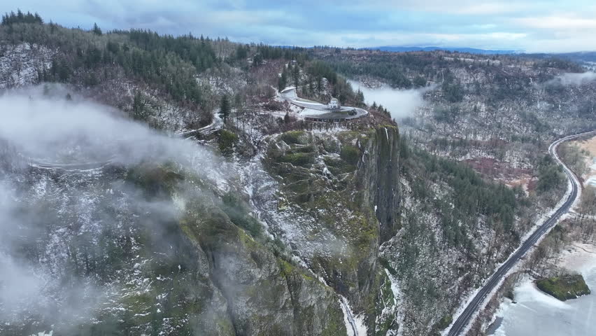 A light dusting of snow covers the Columbia River Gorge near the Crown Point Vista House. This scenic area, not far east of Portland, Oregon, is full of waterfalls and epic outdoor scenery.