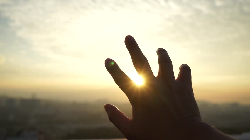 Closeup silhouette hand with sunrise | Shutterstock HD Video #34314937