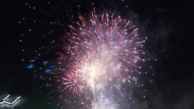 Drone flying above colorful sparkling fireworks exploding at night. Fireworks exploding in sky at Waikiki resorts. Tourists attraction on Oahu island Hawaii. People celebrating life on summer vacation - Powered by Shutterstock - Get 15% off with code: PIKWIZARD15