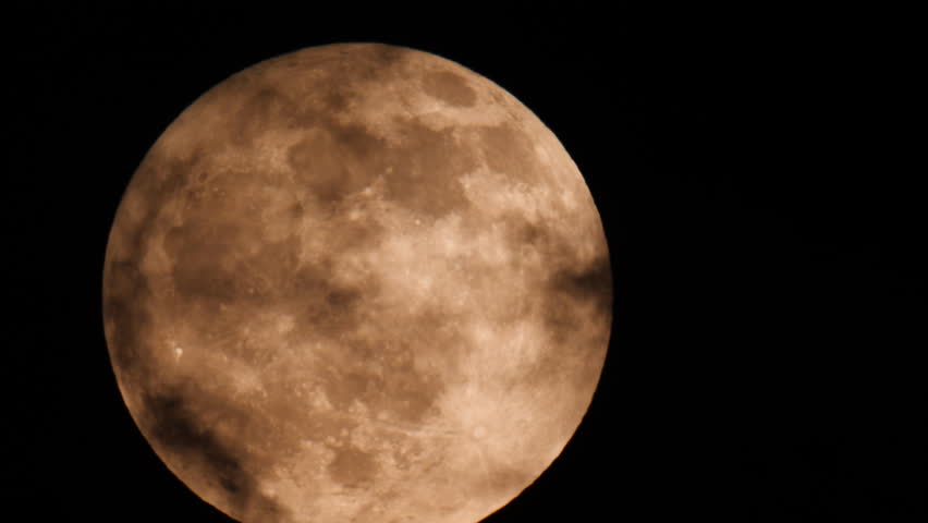 Time Lapse of Big Full Moon Rising or Moving In The Night Sky. Scientific Concept. Dramatic Sky at Night with Clouds over Moon