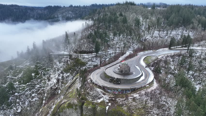 A light dusting of snow covers the Columbia River Gorge near the Crown Point Vista House. This scenic area, not far east of Portland, Oregon, is full of waterfalls and epic outdoor scenery.