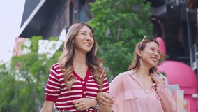Asian young women shopping goods outdoor in shopping street. Attractive young female friends holding shopping bags then walking with happiness enjoy purchasing in department store together.
 - Powered by Shutterstock - Get 15% off with code: PIKWIZARD15