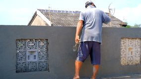 Home Construction Footage. Construction industry. Video of workers plastering walls. Plastering the wall with cement mortar. Shot in 4K Resolution.