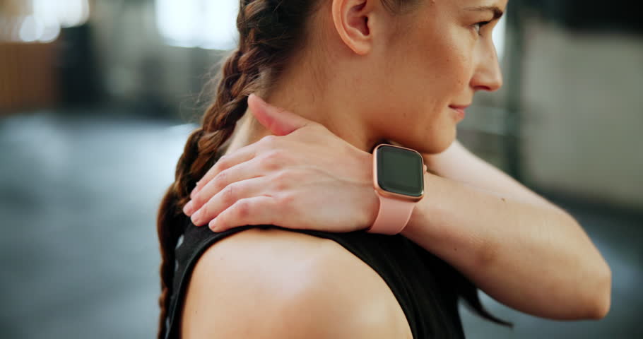 Woman, fitness and hands with neck pain at gym in workout, exercise or tension for inflammation or ache. Closeup of female person with sore muscle, pressure or sports accident from indoor training Royalty-Free Stock Footage #3431794997