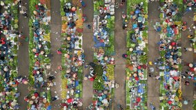 Vertical video. Top view of colorful local outdoor farmers market in rural Vietnam.