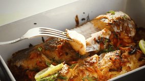 fish baked with spices and vegetables in the oven.
