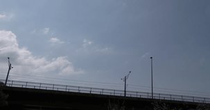 Bridge (with audio:traffic sounds and birdsong ): cars, clouds, sky