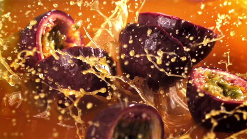 Passion fruit falls into the juice with splashes. Filmed on a high-speed camera at 1000 fps. High quality FullHD footage