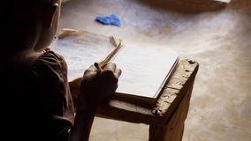 black african children kid study alone writing on notebook preparing homework for school in remote village of Africa - Powered by Shutterstock - Get 15% off with code: PIKWIZARD15