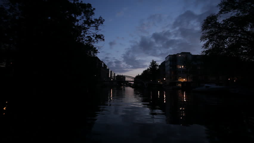Low angle view of city canal at dusk in Amsterdam