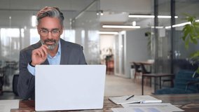 Serious mature European business man ceo trader using computer, typing, working in modern office, doing online data market analysis, thinking planning tech strategy looking at laptop with copy space. - Powered by Shutterstock - Get 15% off with code: PIKWIZARD15