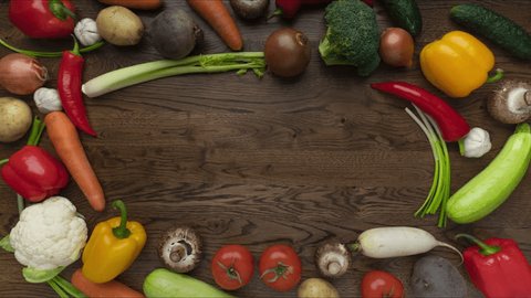 Moving vegetables on kitchen table, wooden background - stop motion animation, 4k, place for title 库存视频