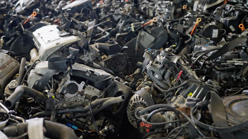 Old Car Engine in the Repair Shop Footage. Used auto parts pile of old car at garage, Mechanical parts, heap of auto parts, old rusty iron chains.