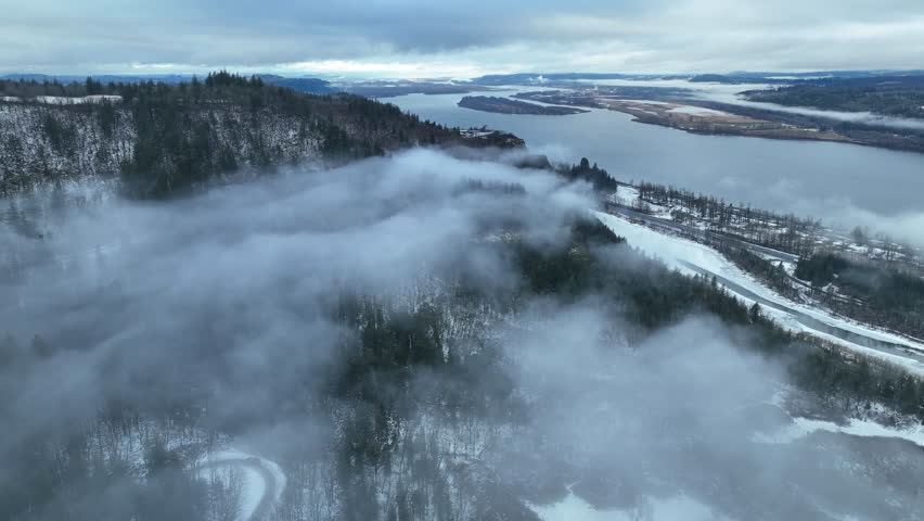 A light dusting of snow covers the Columbia River Gorge near the Crown Point Vista House. This scenic area, not far east of Portland, Oregon, is full of waterfalls and epic outdoor scenery.
