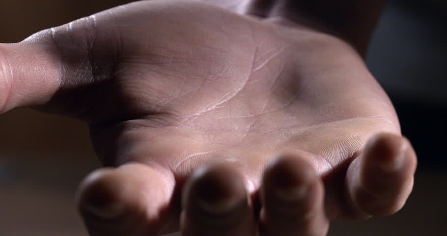 Super slow motion macro of renewable energy sources heating wood compressed pellets are falling on workers hand for quality control at 1000 fps.