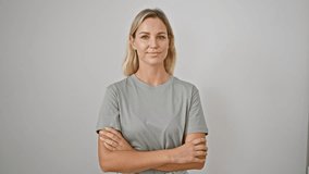 Portrait of a smiling young caucasian woman in a grey shirt with her arms crossed against a white background. - Powered by Shutterstock - Get 15% off with code: PIKWIZARD15