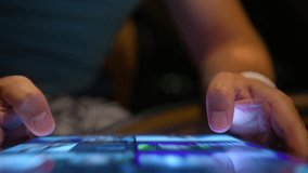 Top view modern tech device bright screen 4K. Young man scrolling content online, wireless internet. Closeup male hands searching on tablet screen, browsing videos, images content using WiFi at night  - Powered by Shutterstock - Get 15% off with code: PIKWIZARD15