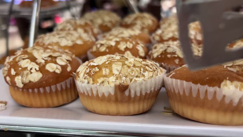 Healthy cupcakes. Banana bread muffins with nuts and oatmeal. Macro video. Cupcake inside, visible texture, broken baking on the wire rack .oatmeal muffin Royalty-Free Stock Footage #3432303133