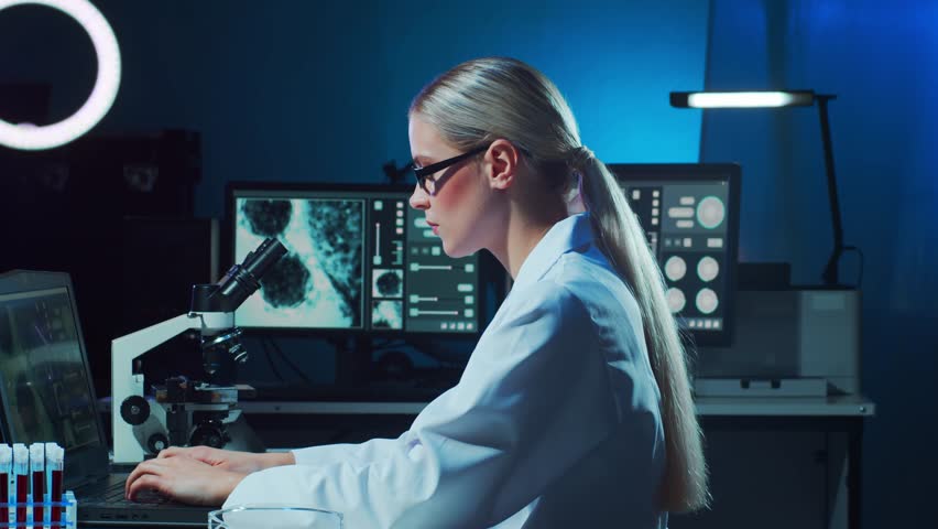 Scientist working in lab. Female doctor making medical research. Laboratory tools: microscope, test tubes, equipment. Coronavirus 2019-ncov, biotechnology, science, experiments and healthcare. Royalty-Free Stock Footage #3432316747