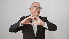 Elderly man in business attire smiling with joy, making a heart shape symbol with fingers to express love. a romantic concept on a white isolated background. - Powered by Shutterstock - Get 15% off with code: PIKWIZARD15